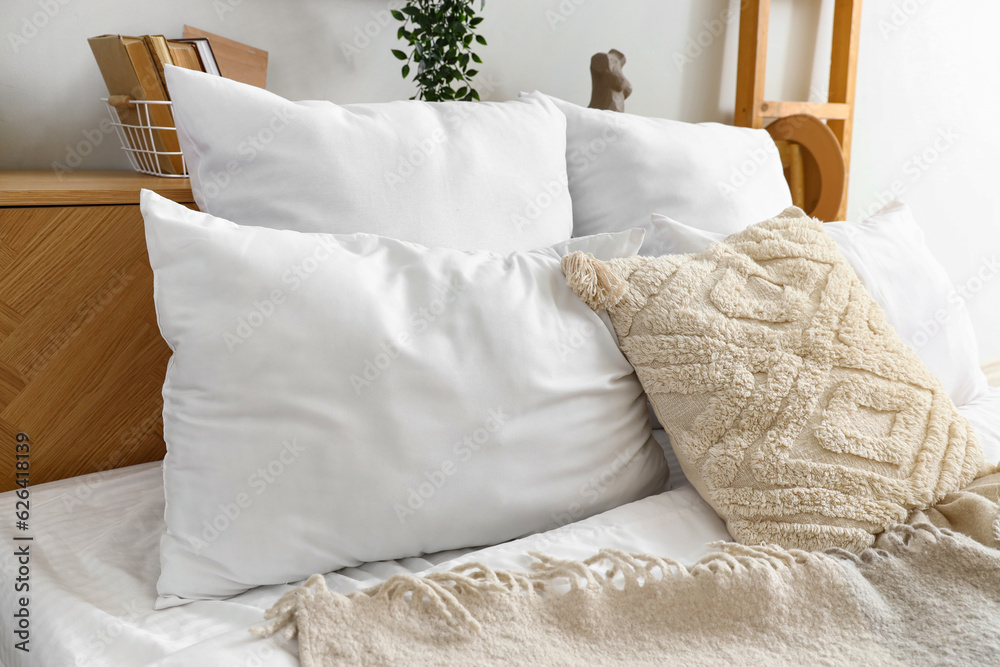 White pillows on bed in bedroom, closeup