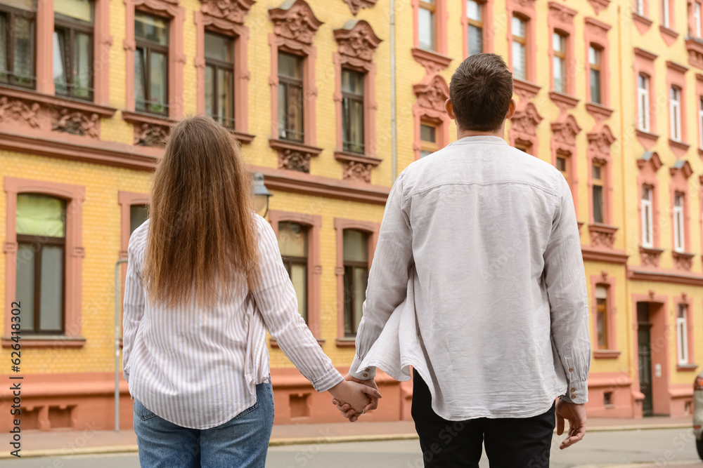 Beautiful happy couple walking in city on spring day