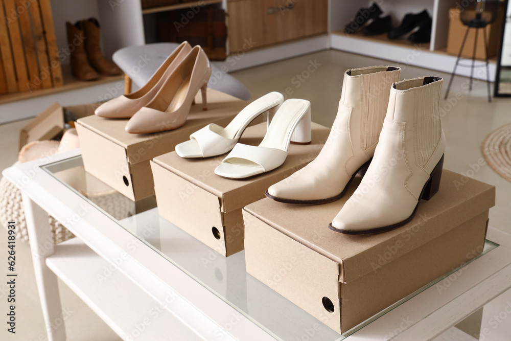 Table with stylish female shoes in boutique, closeup