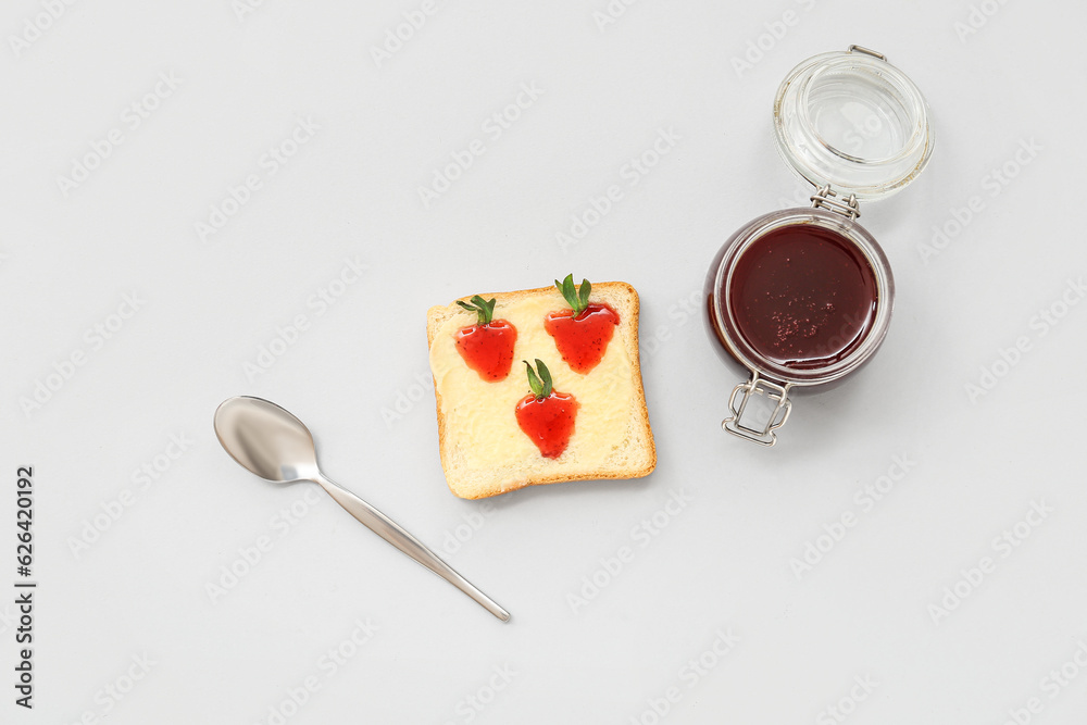 Tasty toast with sweet strawberry jam on grey background