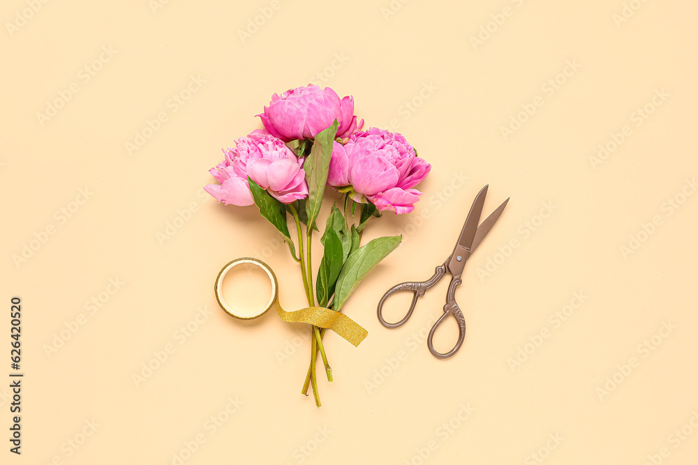 Beautiful peony flowers, scissors and adhesive tape on color background