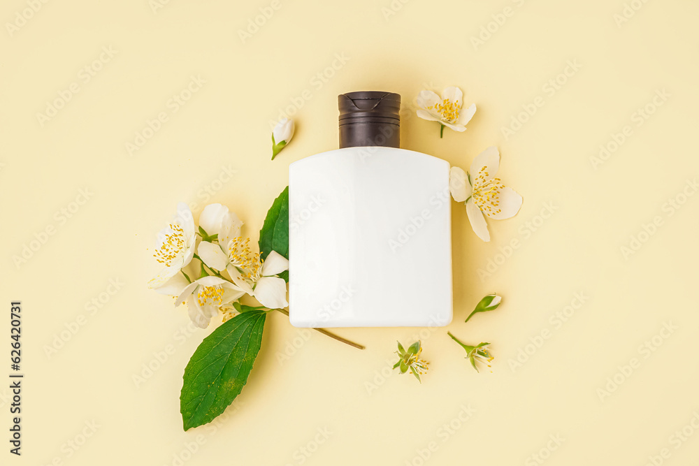 Bottle of cosmetic product and beautiful jasmine flowers on color background