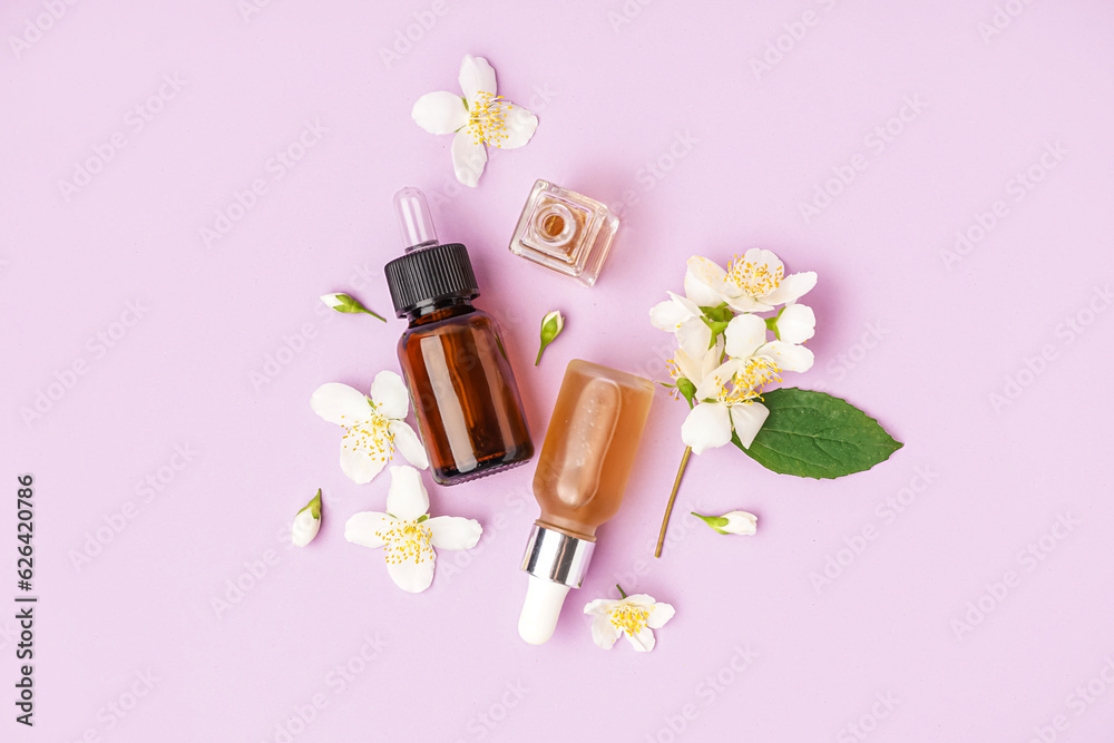 Composition with bottles of essential oil and beautiful jasmine flowers on lilac background