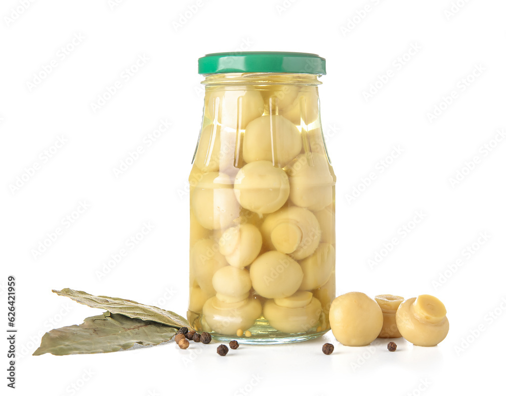 Jar with canned mushrooms on white background