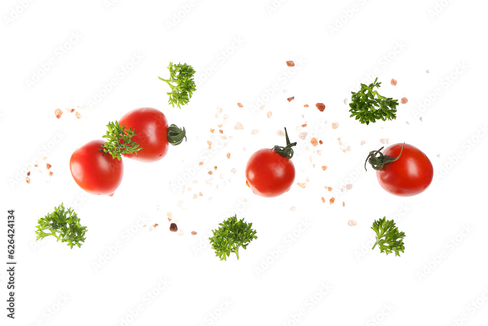 Flying, tomatoes, parsley and sea salt on white background