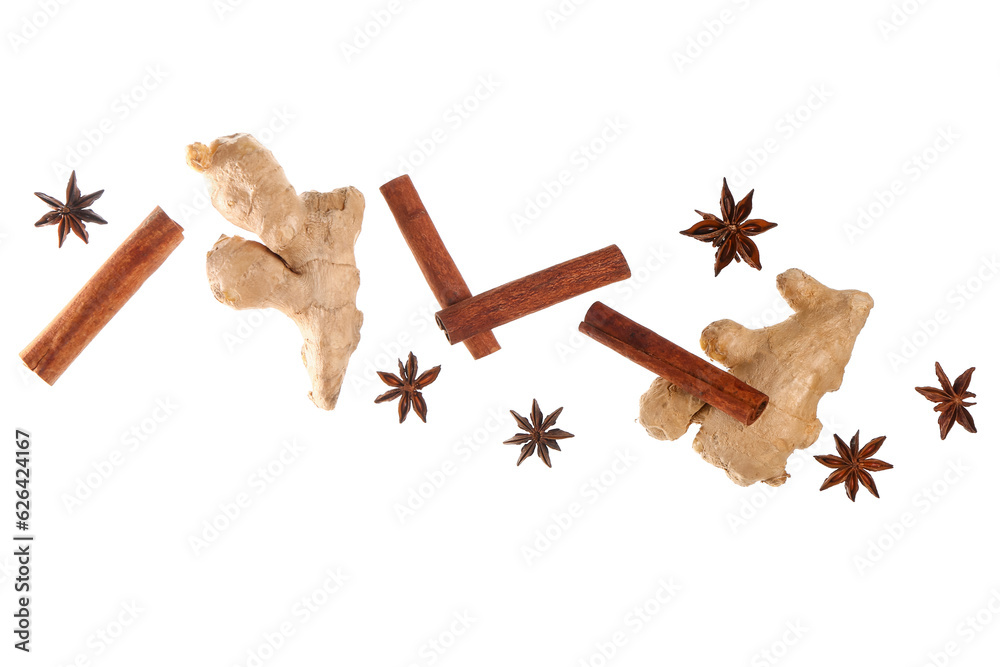 Flying cinnamon sticks, anise stars and ginger roots on white background