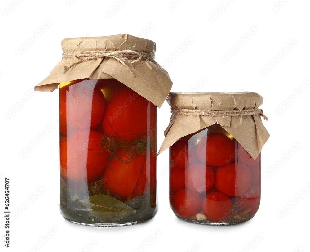 Jars with canned tomatoes on white background