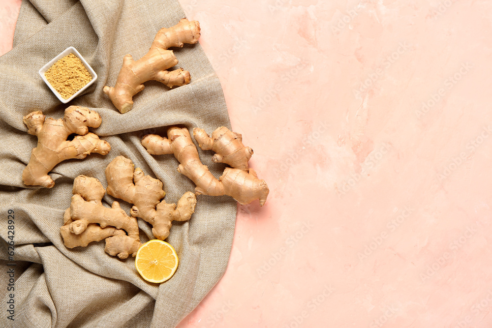 Fresh ginger roots, half of lemon and bowl of dried powder on pink background