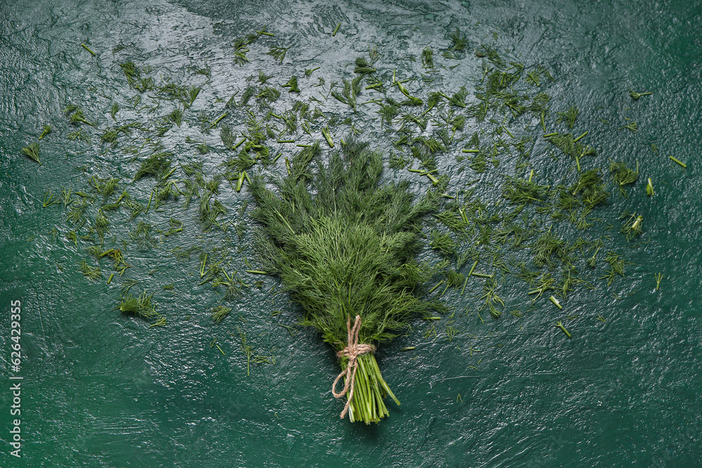 Bunch of fresh dill on green background