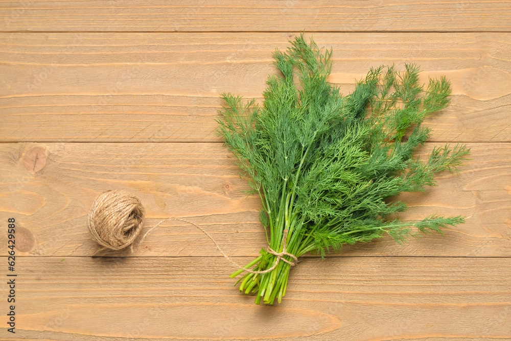 Bunch of fresh dill on wooden background