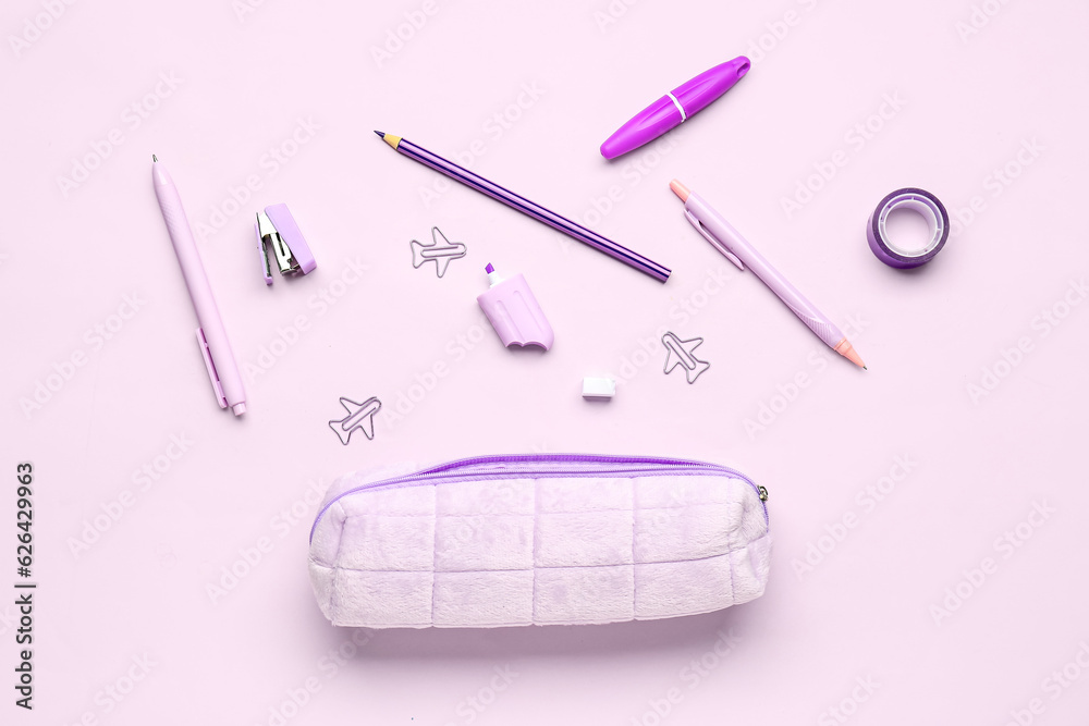 Pencil case with different stationery on lilac background