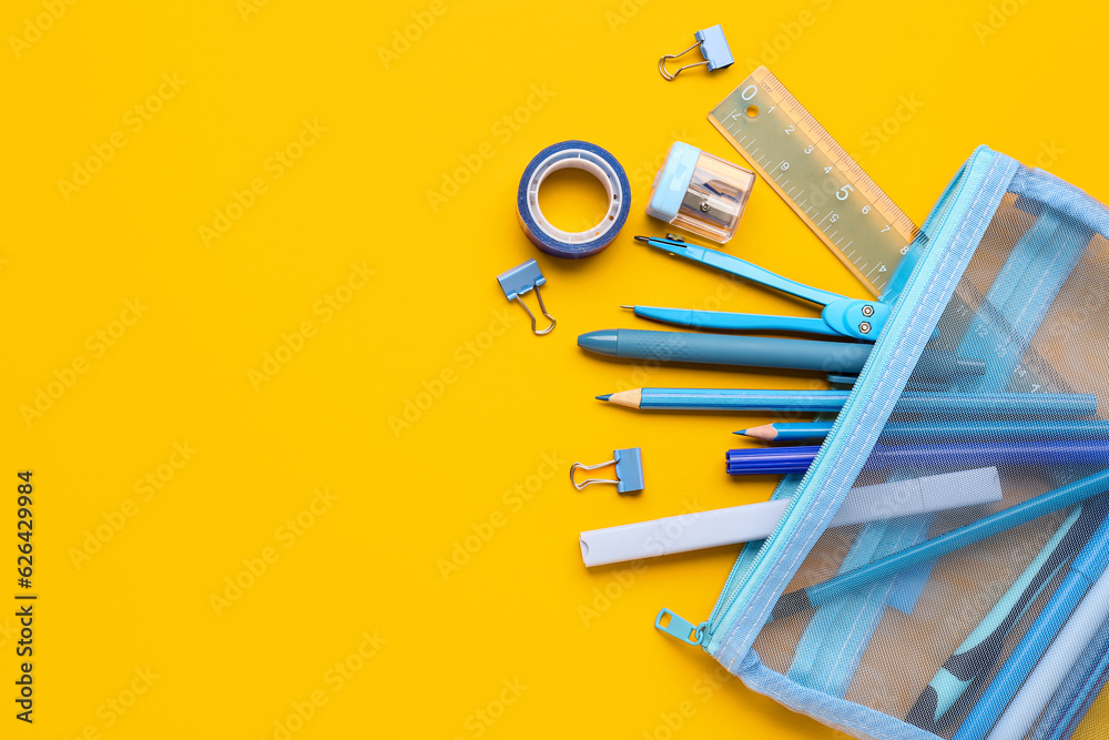 Pencil case with different stationery on orange background