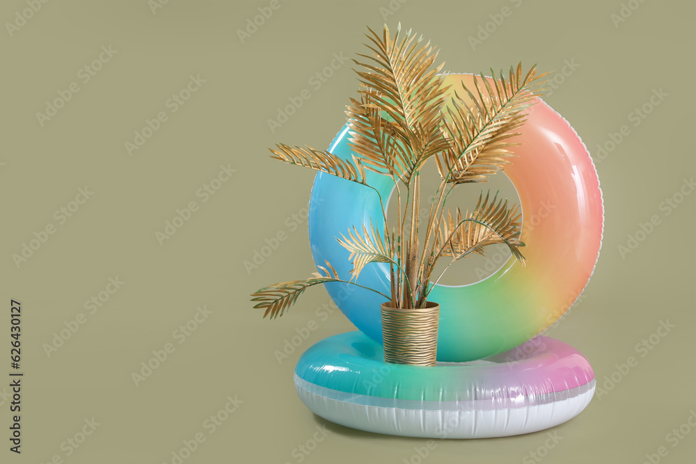 Swim rings with golden palm on green background