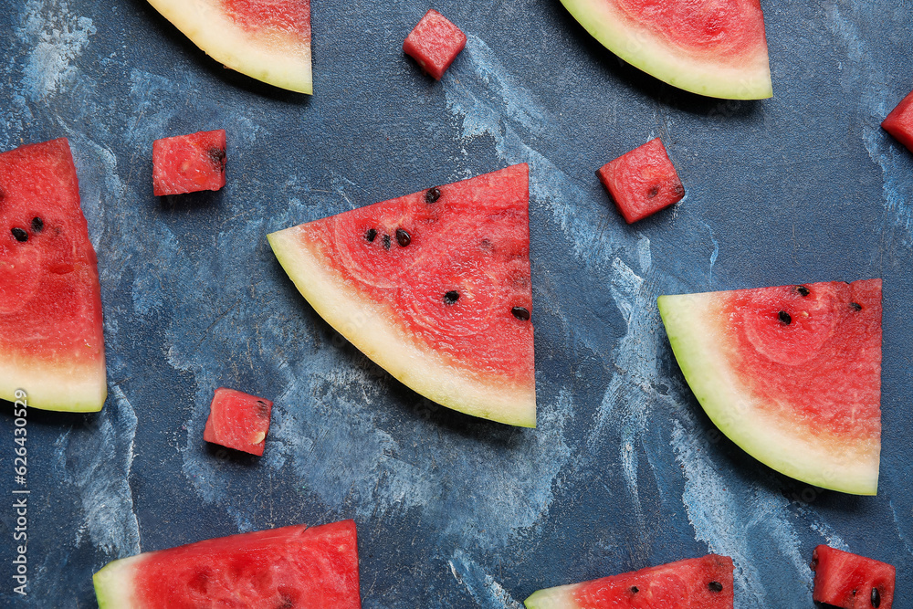 Composition with different pieces of ripe watermelon on blue background