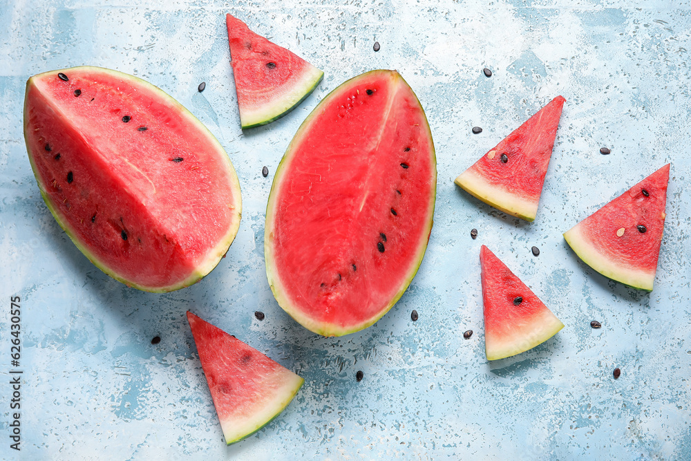 Composition with pieces of ripe watermelon on light blue background