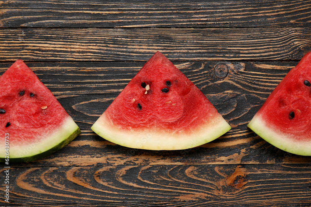 Composition with pieces of ripe watermelon on wooden background, closeup