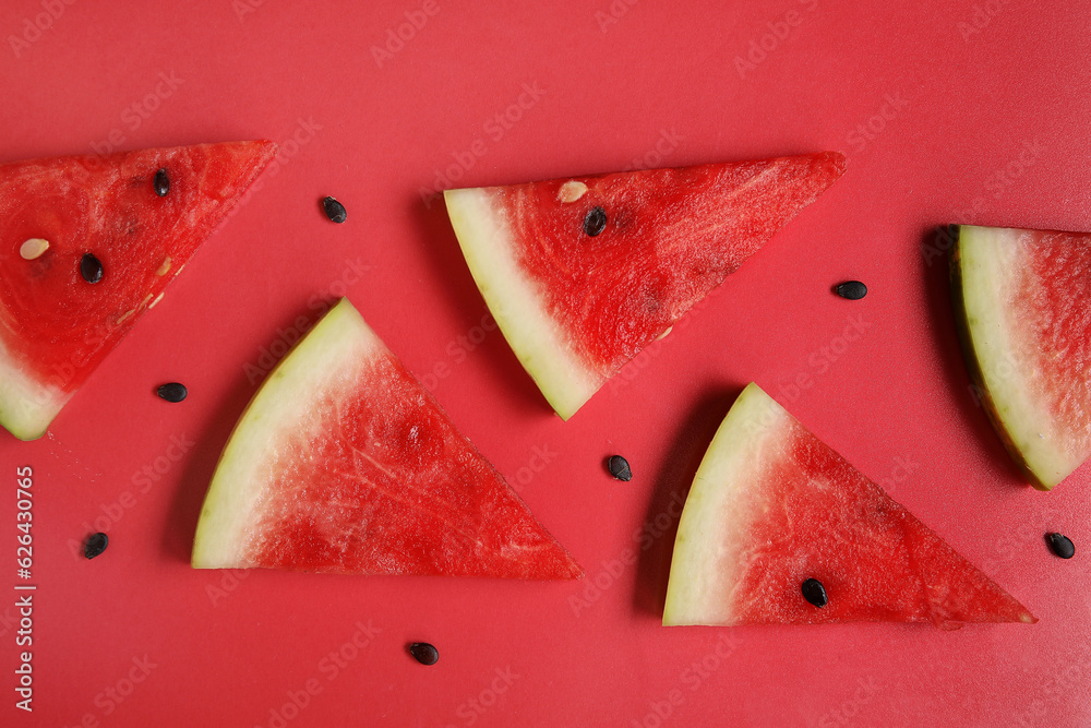 Composition with pieces of ripe watermelon on red background