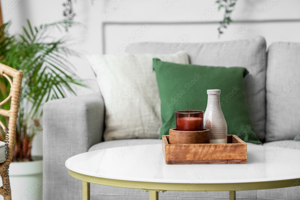 Box with candle and vase on coffee table in living room