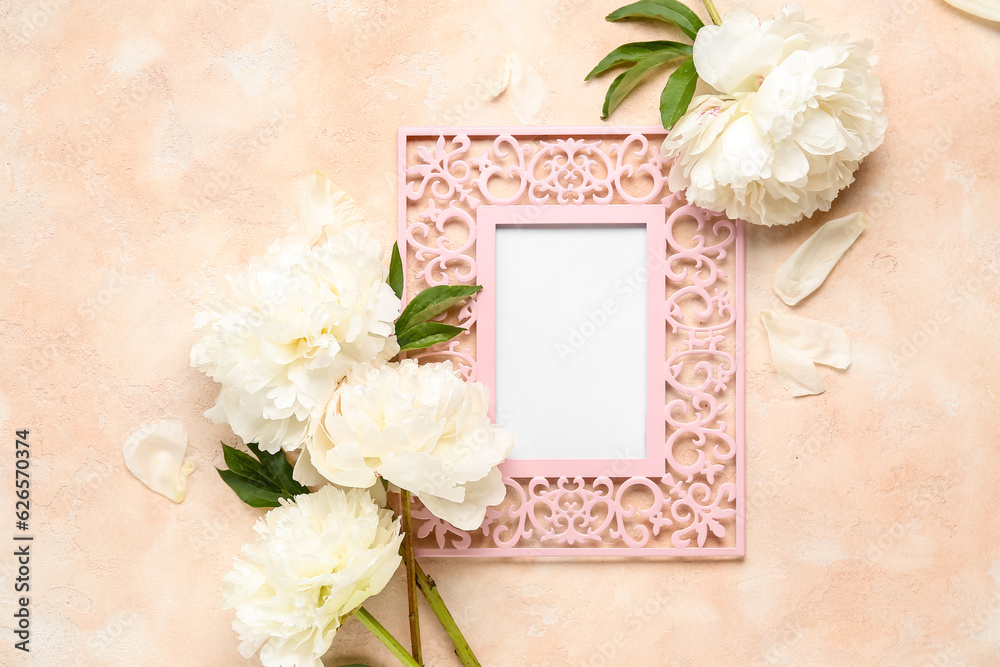 Composition with blank picture frame and beautiful peony flowers on color background