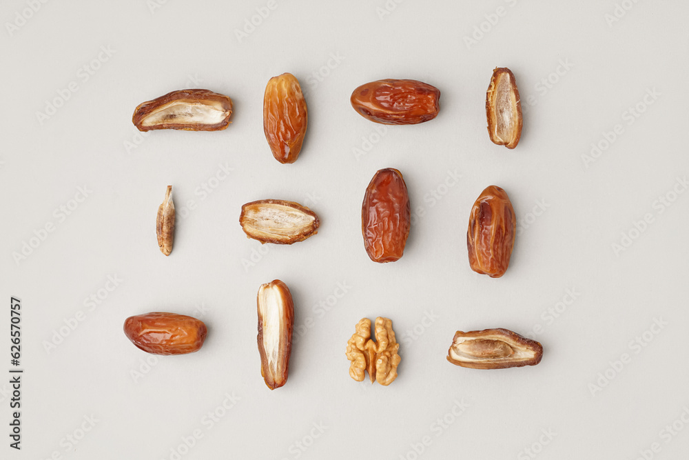 Dried dates and walnut on light background