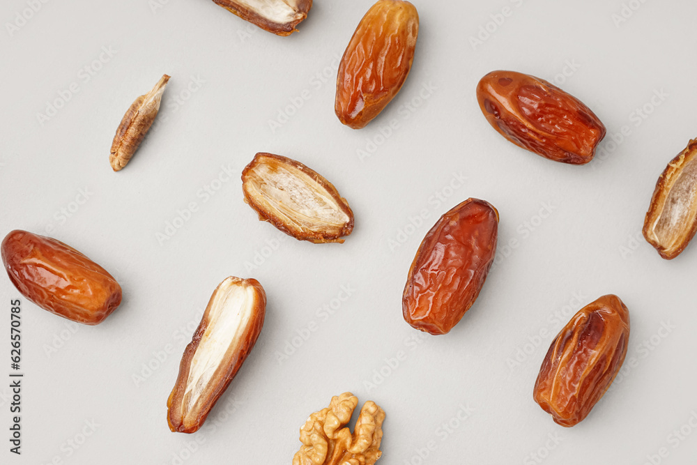 Dried dates and walnut on light background