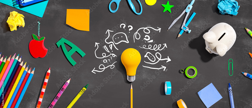 Brainstorming concept with a light bulb and school supplies - Flat lay