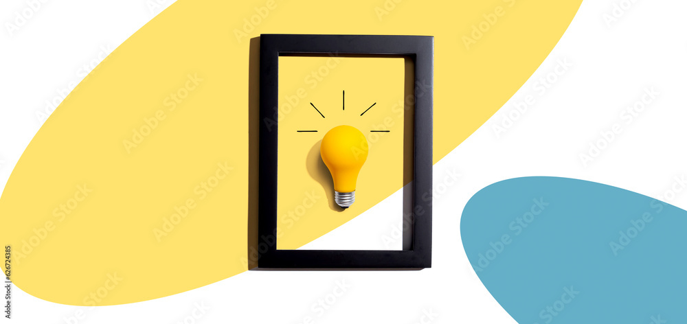 Yellow light bulb inside a frame - inspiration, creativity, energy, electricity themes