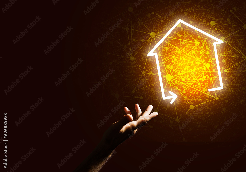 Conceptual image with hand pointing at house or main page icon on dark background