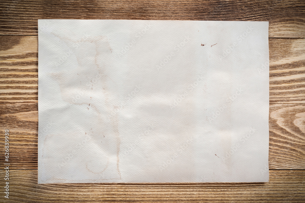 Sheet of paper lying on wooden table