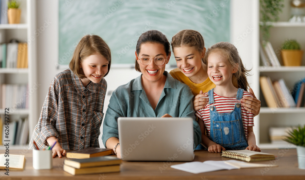 Happy kids and teacher at school