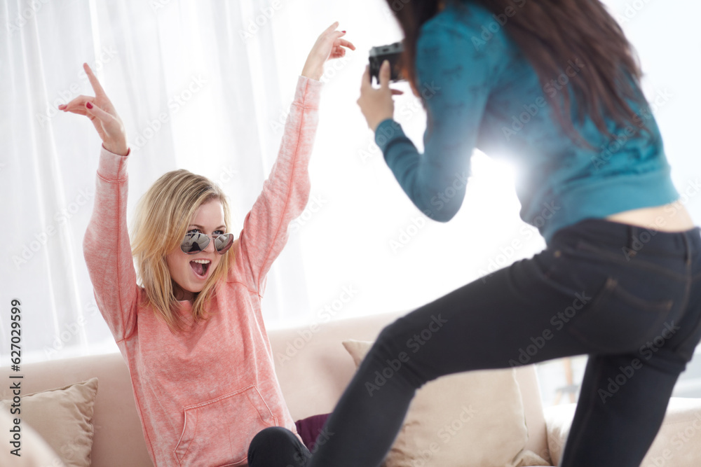 Crazy women friends with a photography camera in happiness together and being silly in a home living