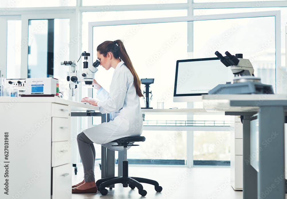 Paying close attention to detail. Cropped shot of a focused young female scientist looking through a