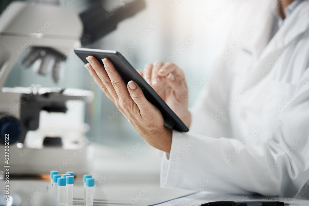 Making a record of her research. Cropped shot of an unrecognizable mature female scientist using a t