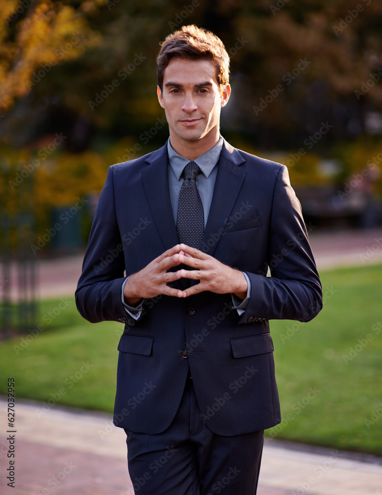 The future is looking bright. Portrait of a handsome and stylish businessman standing in a city park