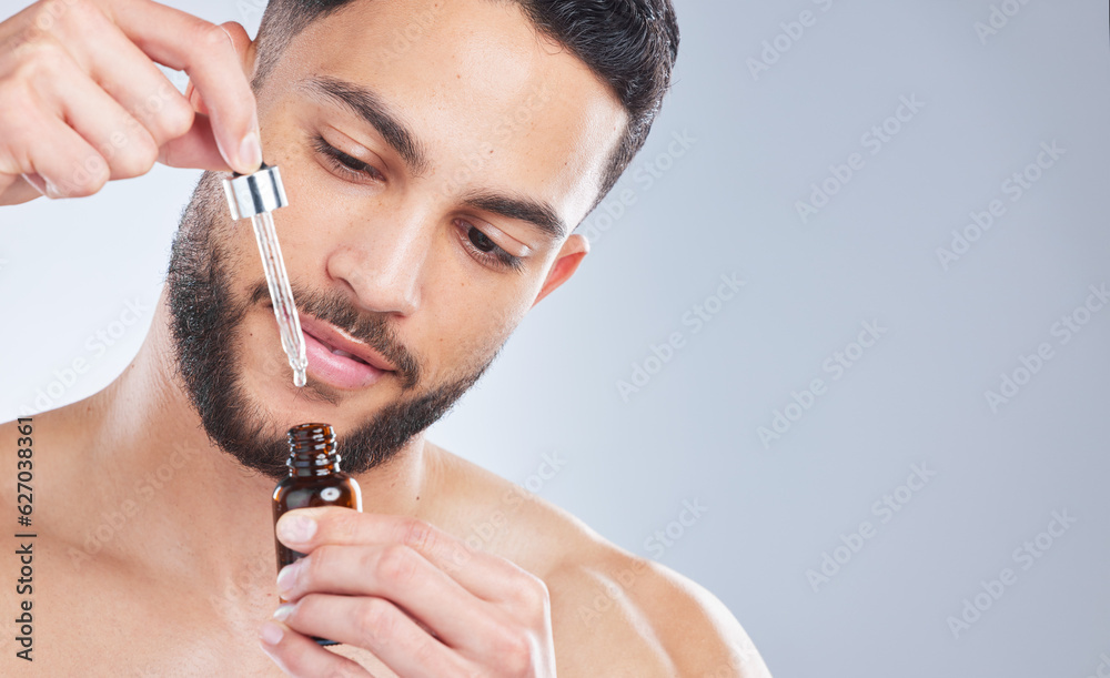 Mockup, serum and man with skincare, cosmetics and dermatology against a grey studio background. Mal