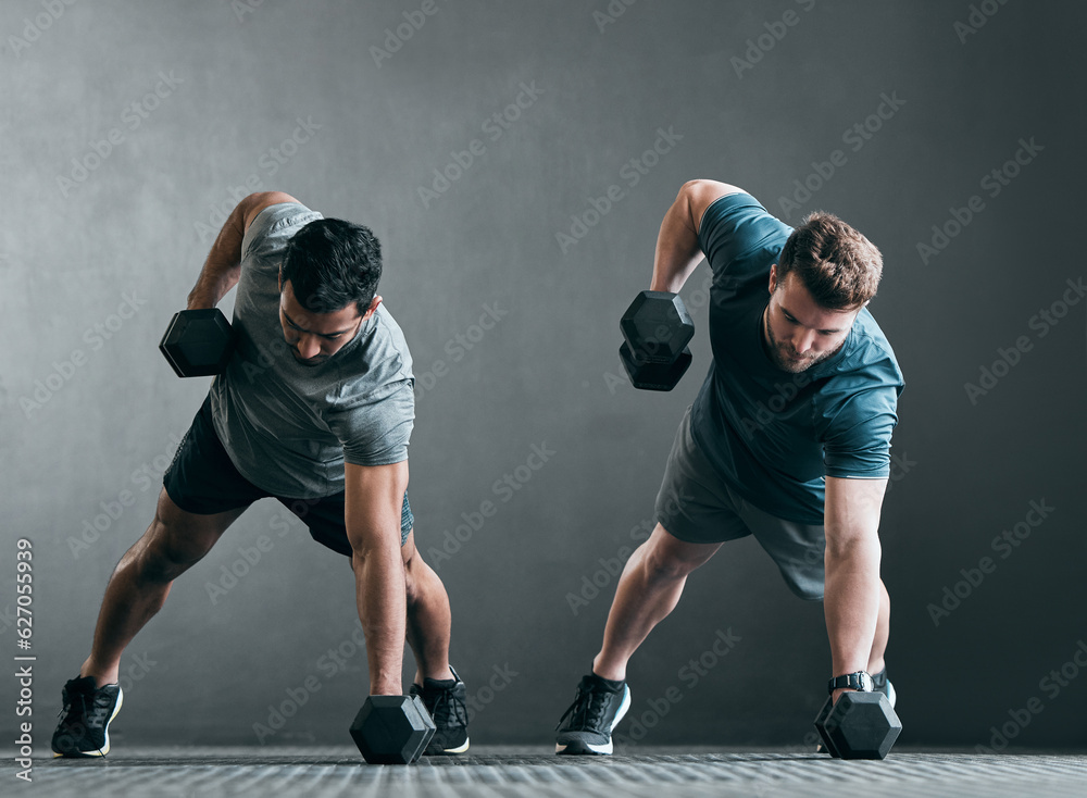 Fitness, men and dumbbell push up for exercise with focus, power and strong muscle with a grey backg