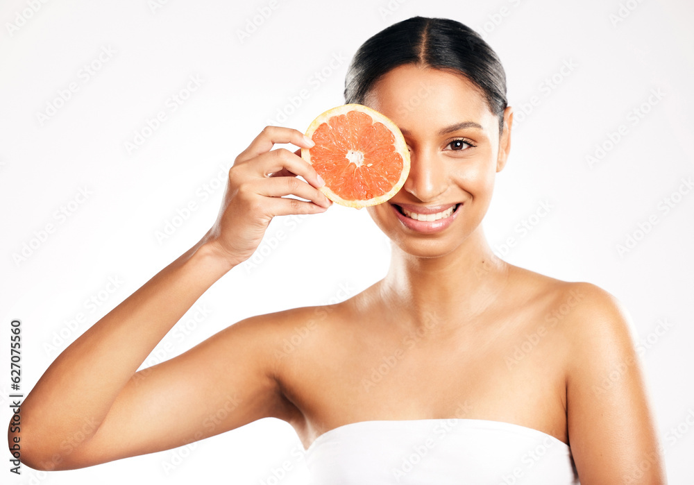 Happy woman, portrait and grapefruit for vitamin C, diet or skincare against a white studio backgrou