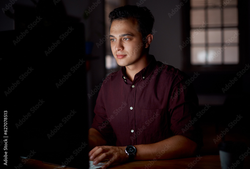 Wrapping up some deadlines. Shot of a young businessman working on a computer in an office at night.