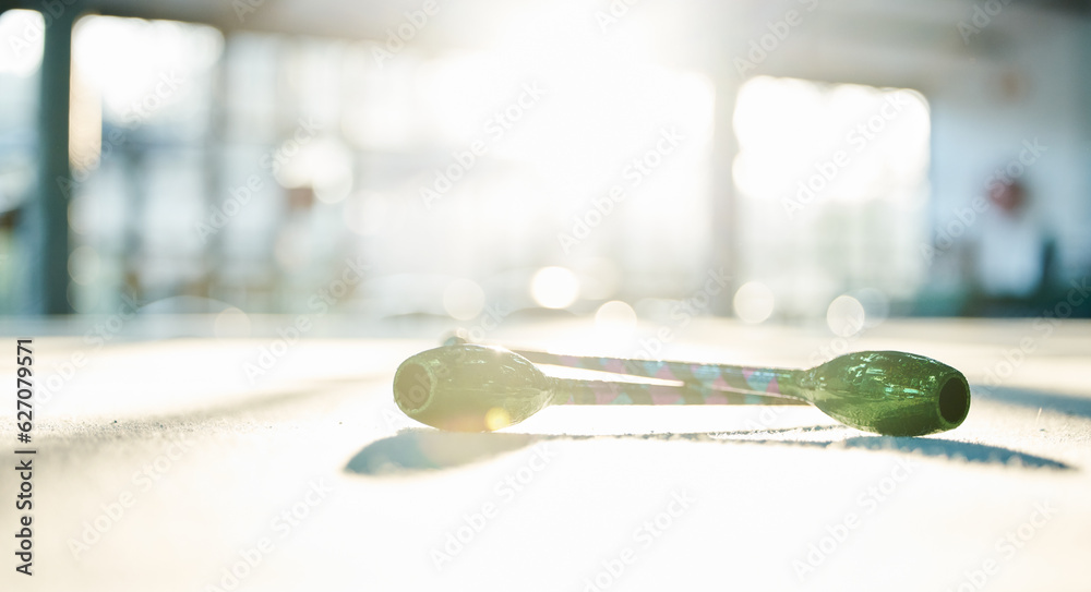 Fitness, dance and ribbon on the floor of a gym or studio for training with flare on a blurred backg