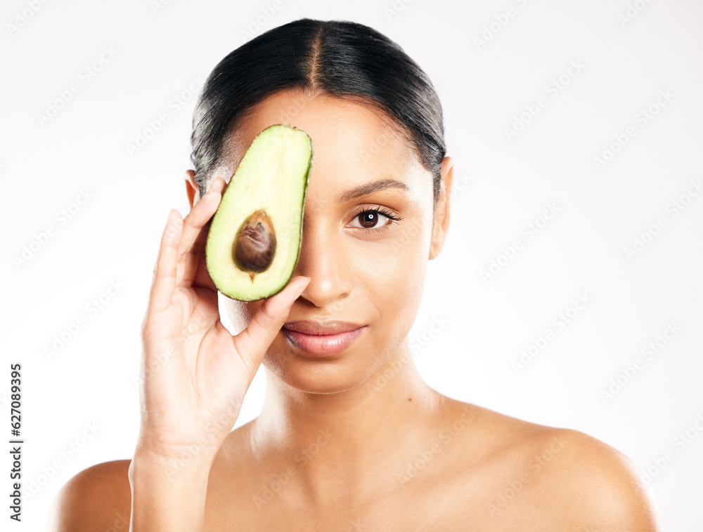 Woman, portrait and avocado on face in skincare, natural beauty or nutrition against a white studio 