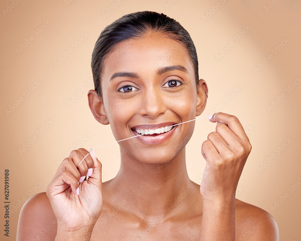 Woman, mouth and flossing in studio portrait with smile, cleaning or teeth whitening by brown backgr