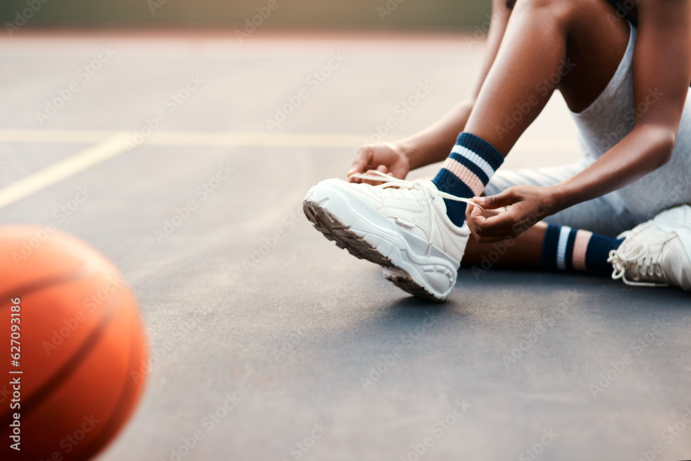 I dont want to trip of the court. Cropped shot of an unrecognizable sportswoman sitting on the court