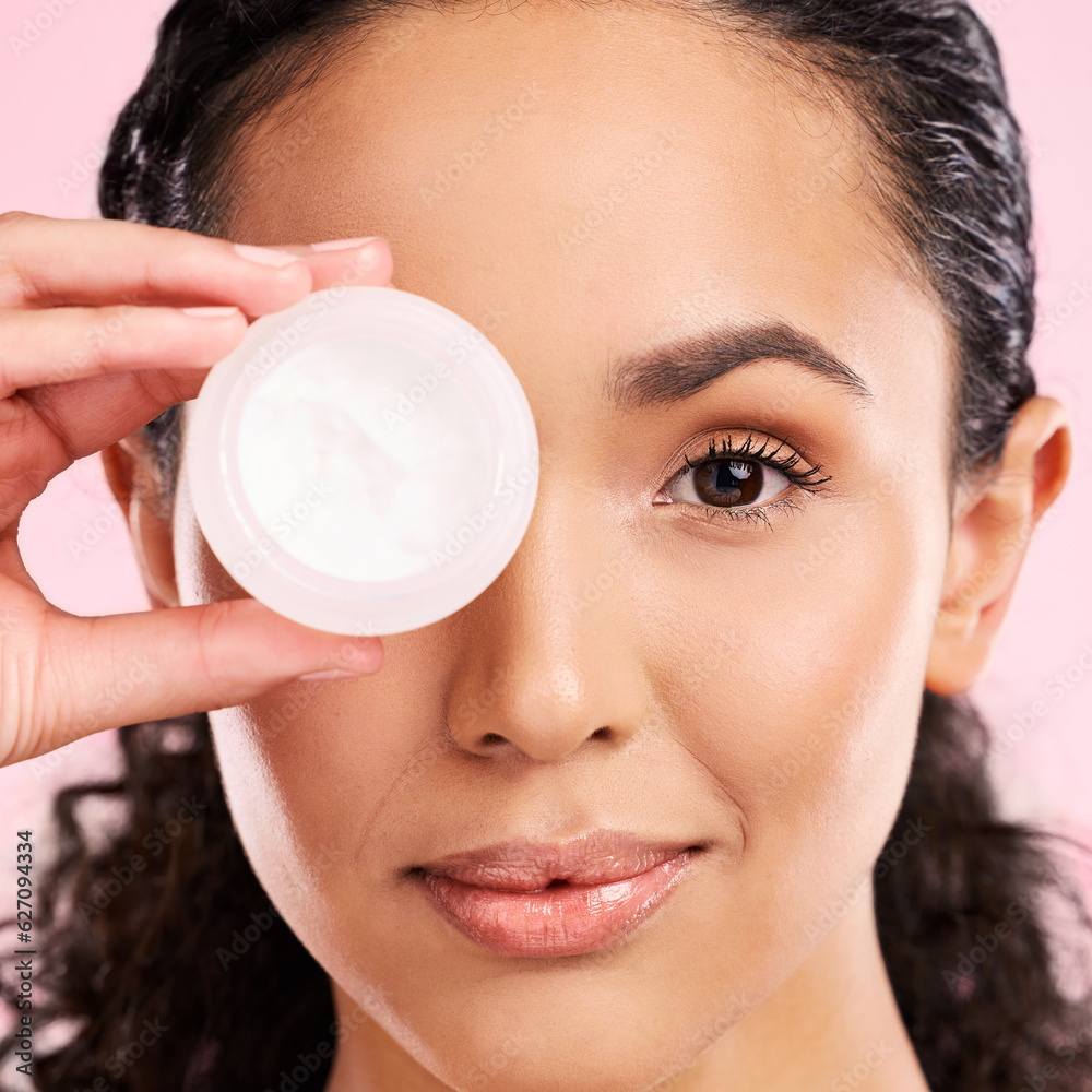 Face, skincare and woman with cream jar in studio isolated on a pink background. Portrait, beauty an