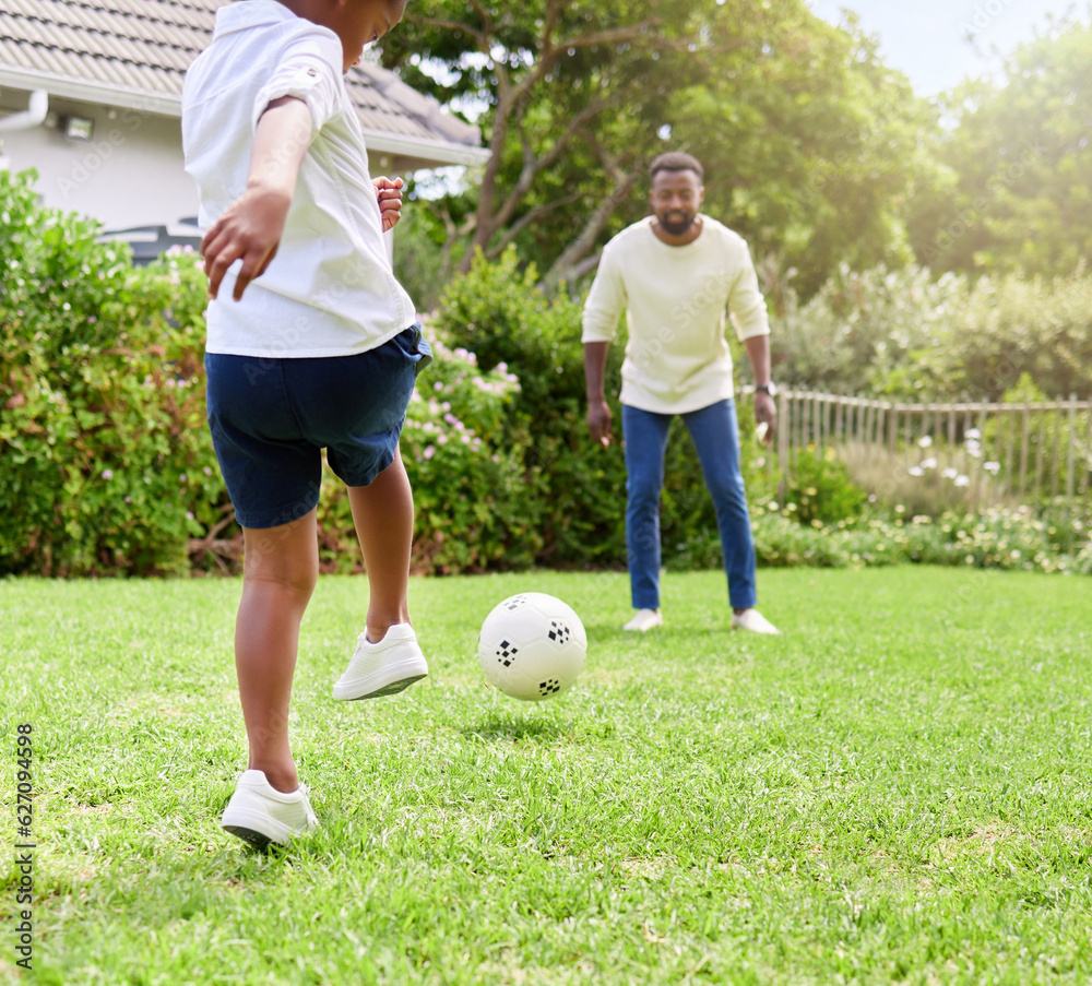 His coordination gets better with practice. Shot of a little boy kicking a soccer ball to his father