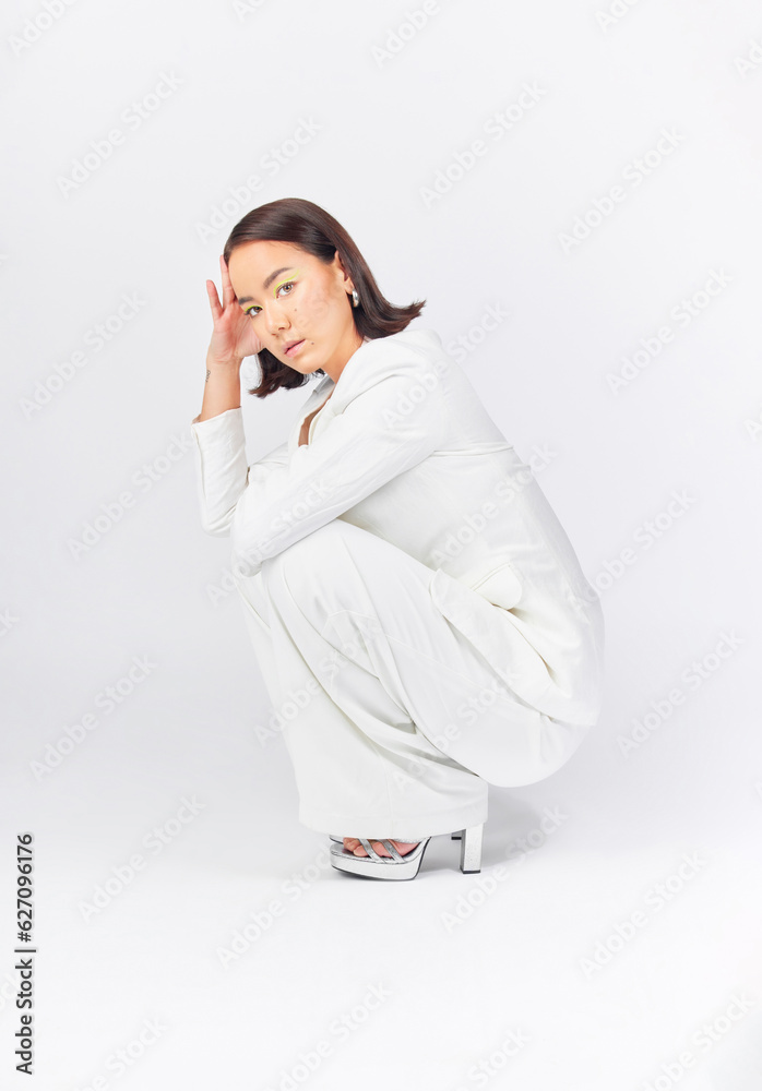 Fashion, suit and portrait of a woman on a studio background with confidence and class. Stylish, ser