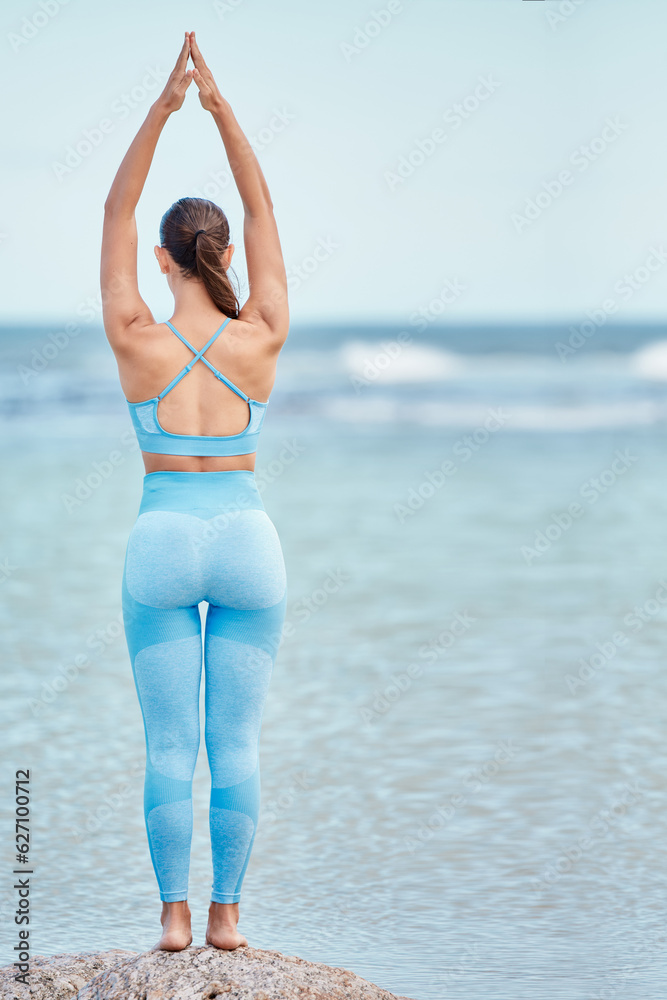 Meditation, fitness and back view of woman at the beach for workout or training as health, mindfulne