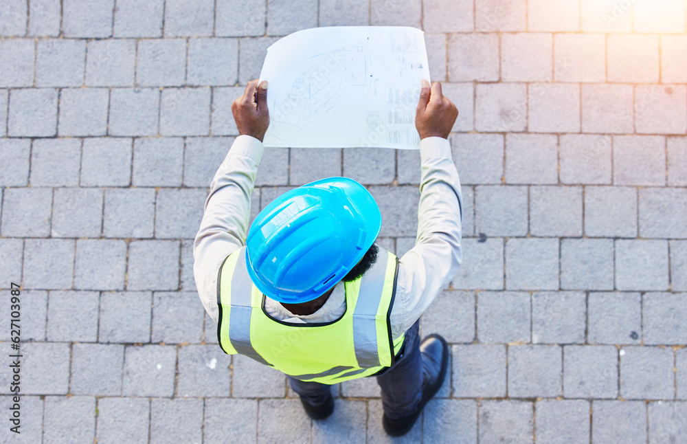 Construction worker, man and building inspection blueprint with industrial employee from above. Afri