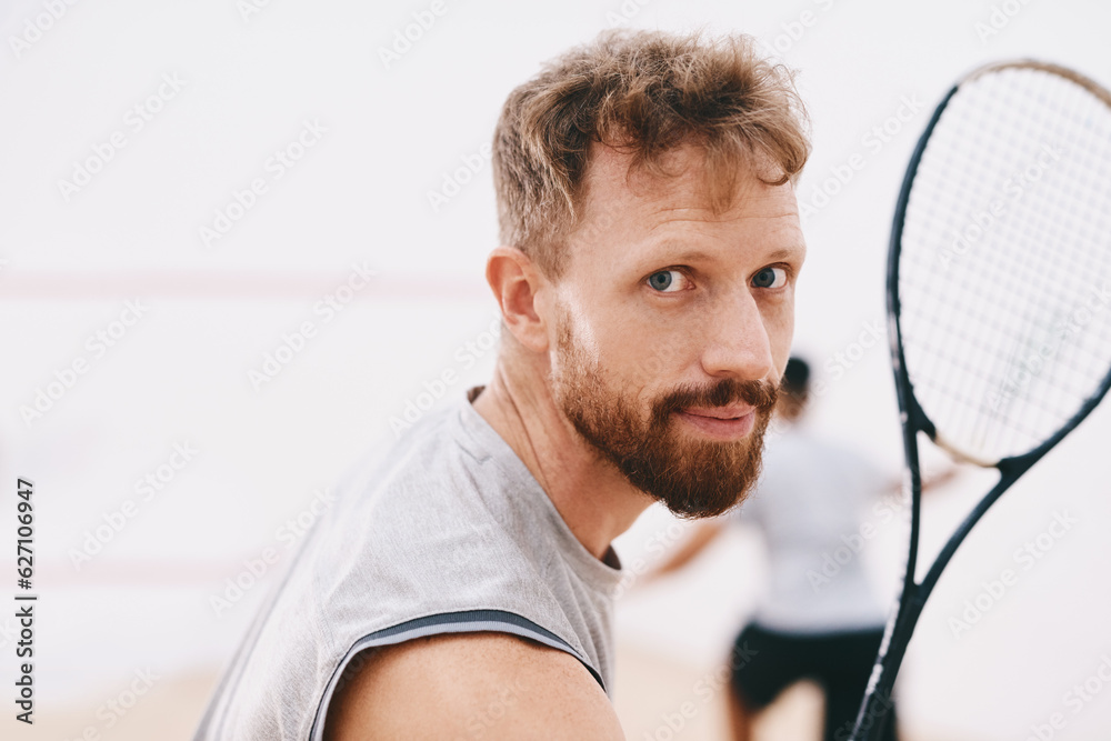 Have my medal ready for me. Portrait of a young man playing a game of squash with his team mate in t