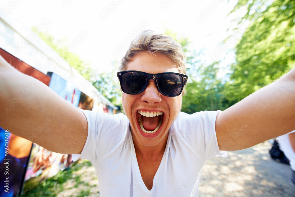 This is gonna be AMAZING. Portrait of a young man shouting at the camera in excitement.