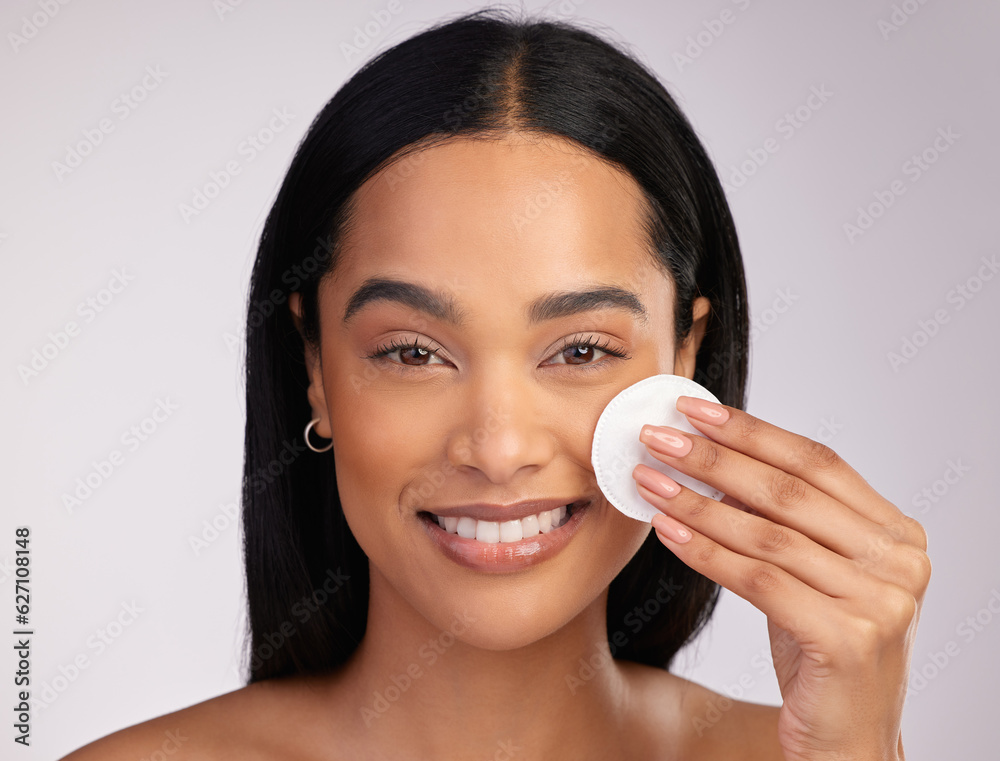 Happy woman, portrait and cotton pad in skincare or makeup removal against a grey studio background.